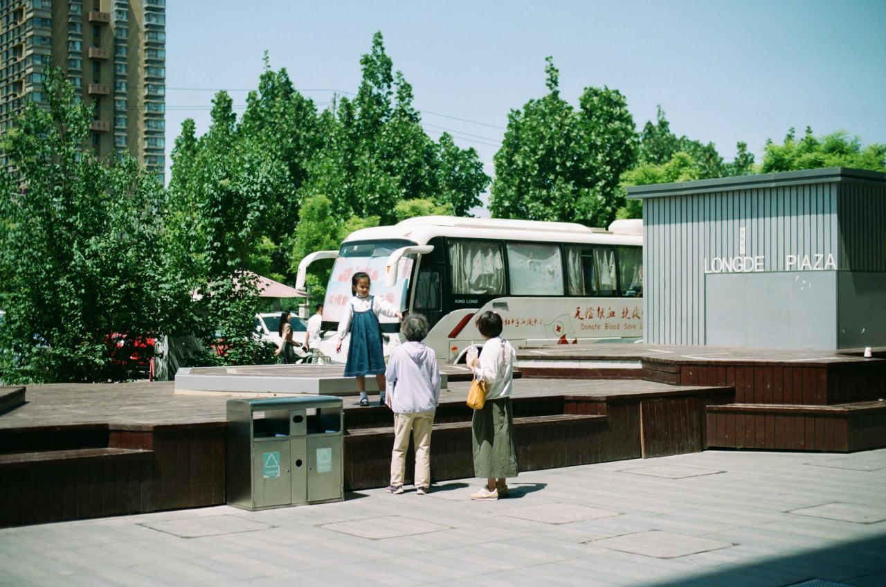 a couple of people standing next to a bus